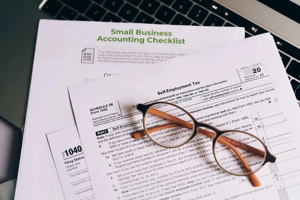 Small Business Tax Paperwork on Desk with Glasses